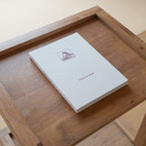 Kissa by Kissa the book on a wooden table